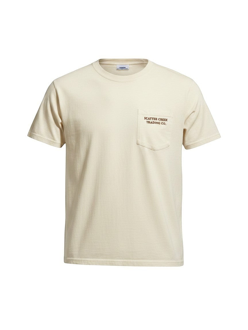 Scatter Creek Trading Co heavyweight garment-dyed cream cotton t-shirt with a left chest pocket and brown logo print.